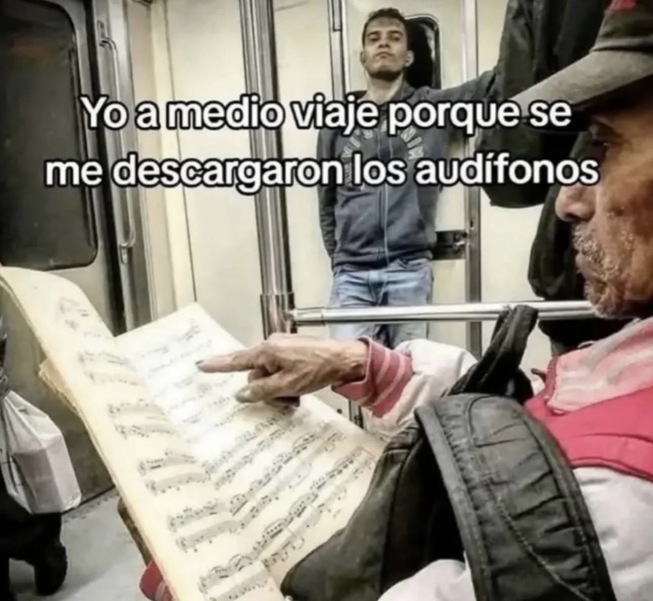 a man is reading a book on a subway